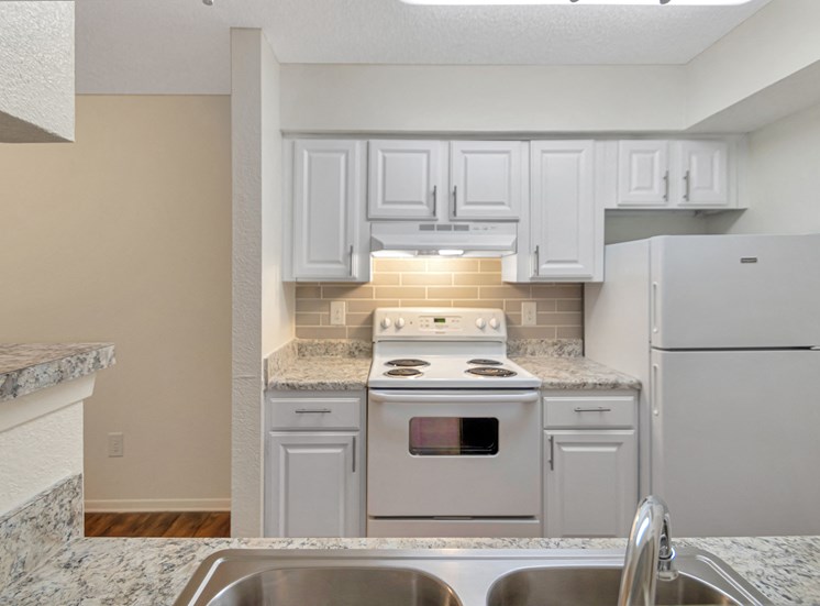 This is a photo of the kitchen in a 827 square foot 2 bedroom, 1 bathroom apartment at The Boulders Apartments in Garland, TX.