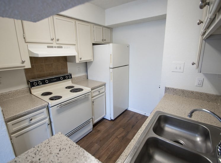 This is a photo of the kitchen in a 1024 square foot 3 bedroom apartment at The Boulders Apartments in Garland, TX.