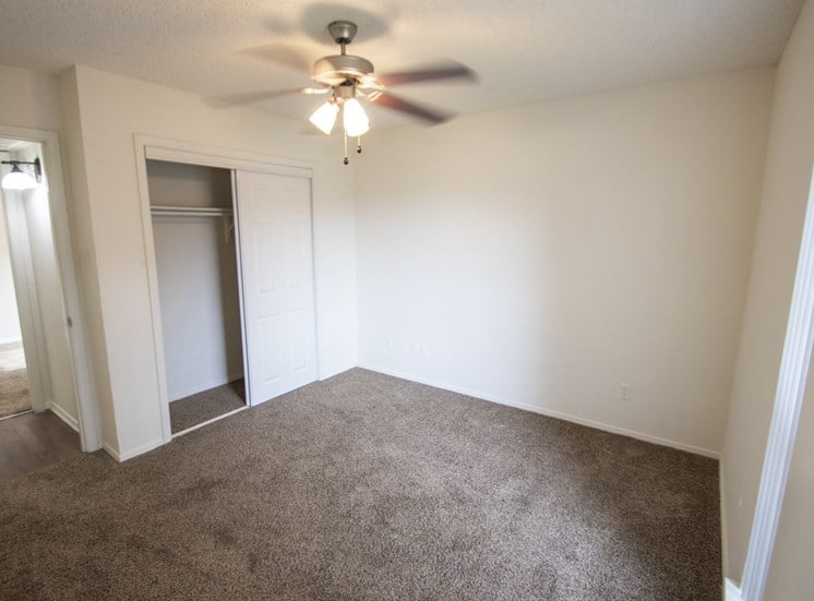 This is a photo of the second bedroom in a 1024 square foot 3 bedroom apartment at The Boulders Apartments in Garland, TX.