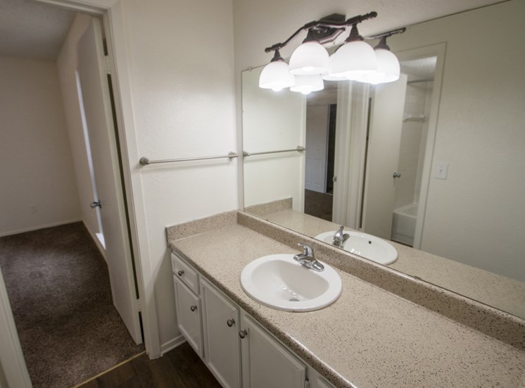 This is a photo of the primary bathroom in a 1024 square foot 3 bedroom apartment at The Boulders Apartments in Garland, TX.