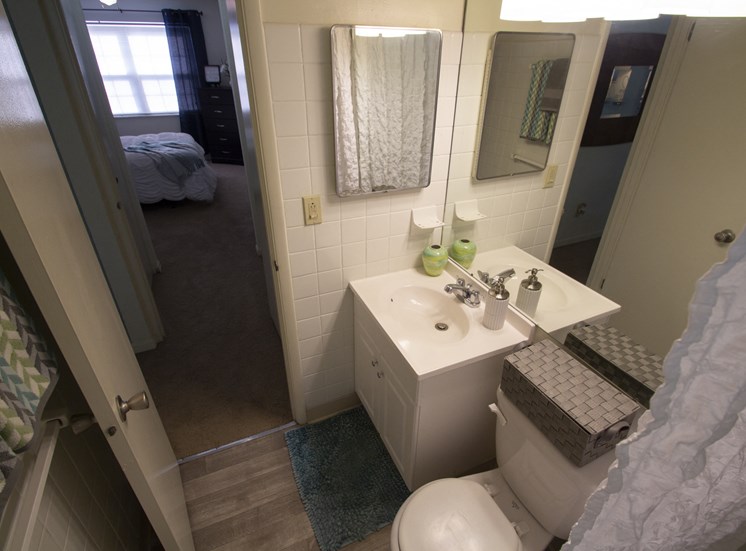 This is a photo of the bathroom of the 550 square foot 1 bedroom, balcony floor plan model apartment at College Woods Apartments in Cincinnati, OH.