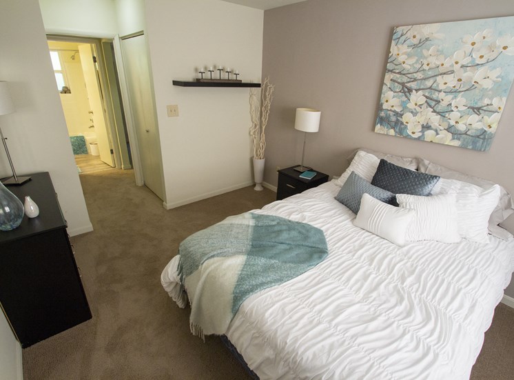 This is a photo of the bedroom of the 550 square foot 1 bedroom, balcony floor plan model apartment at College Woods Apartments in Cincinnati, OH.