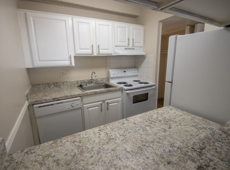 This is a photo of the kitchen in the 653 square foot 1 bedroom apartment at Harvard Square Apartments, in Dallas, TX.