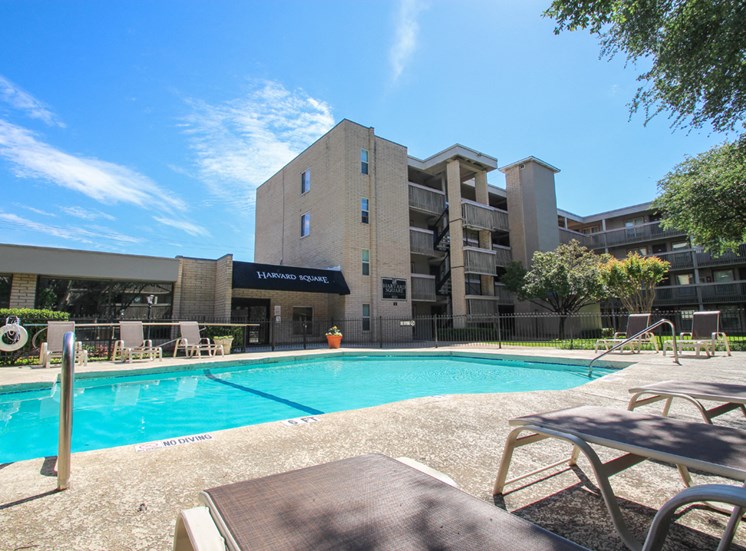 This is a photo of the pool area at Harvard Square Apartments in Dallas, TX.
