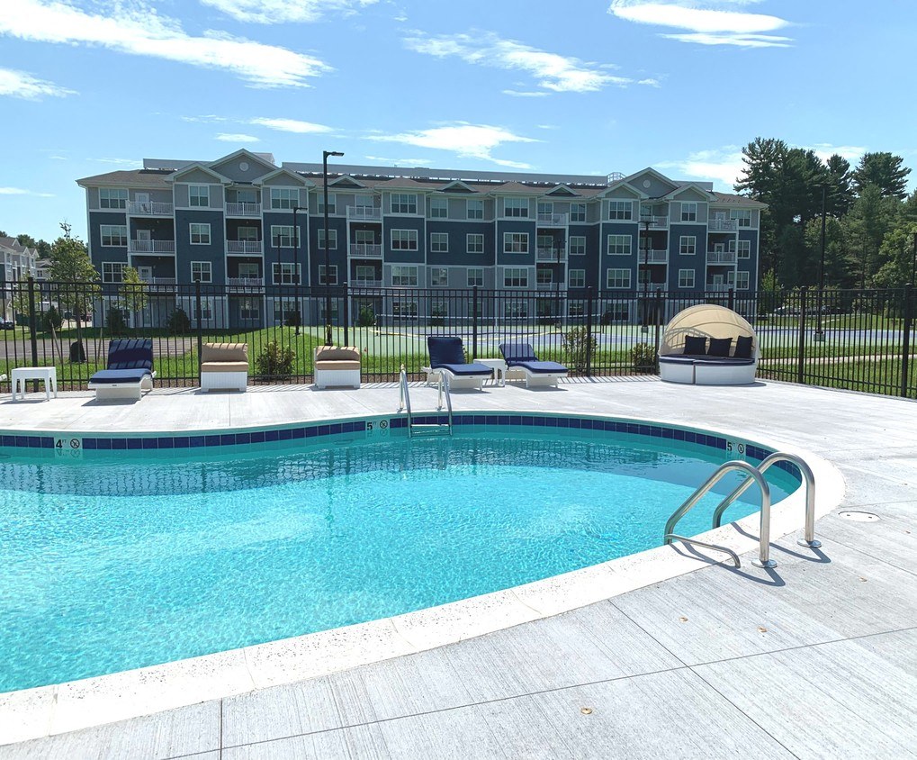 a swimming pool in front of an apartment building