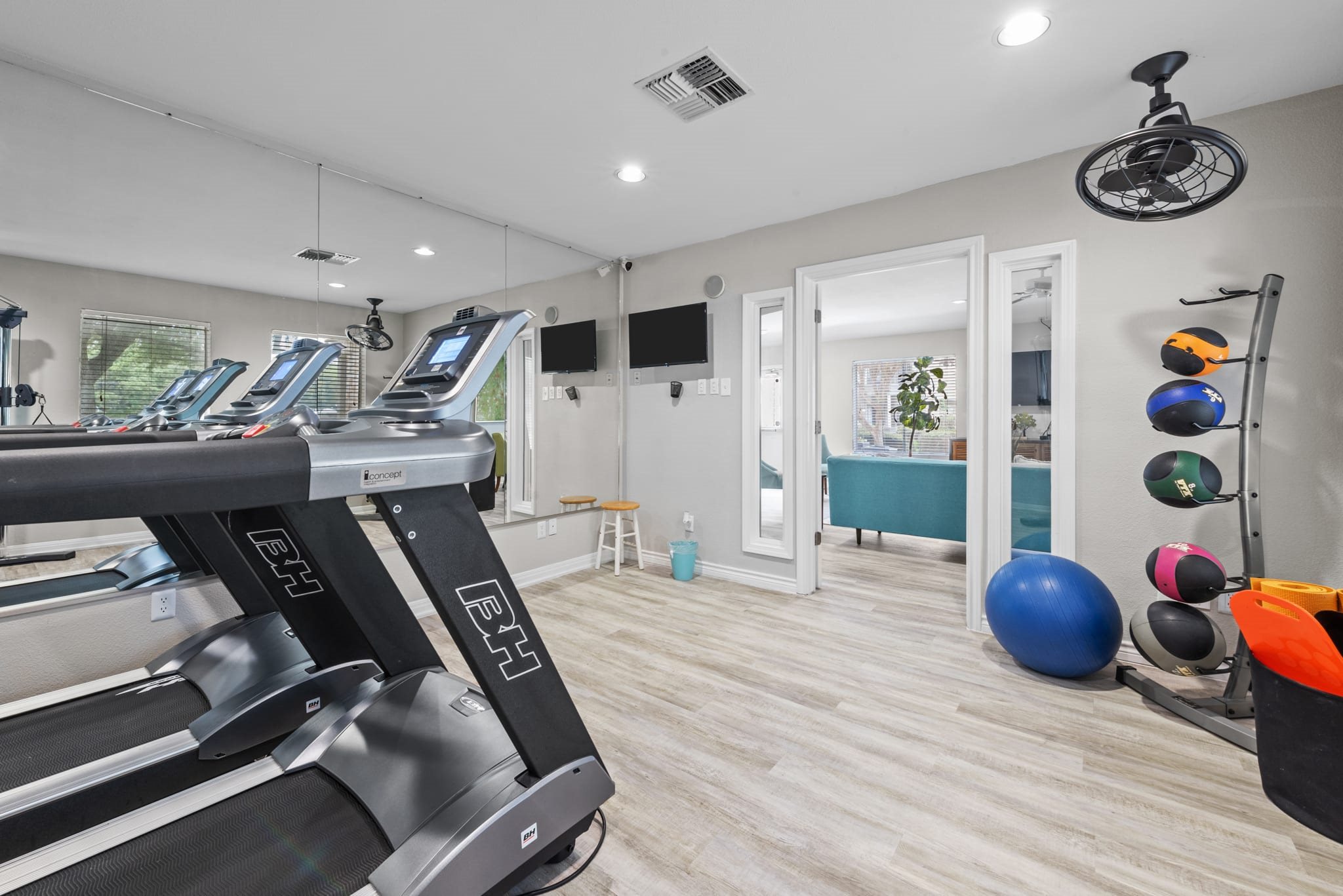 Fitness center with cardio equipment and exercise accessories at Peaks at Universal City Apartments, Universal City, TX