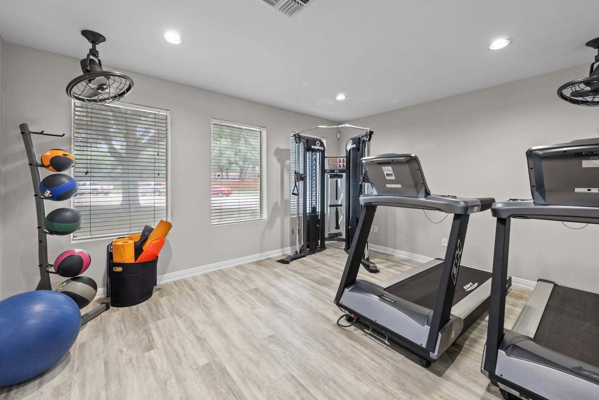 Fitness center with treadmills and weight machines at Peaks at Universal City Apartments, Universal City, Texas