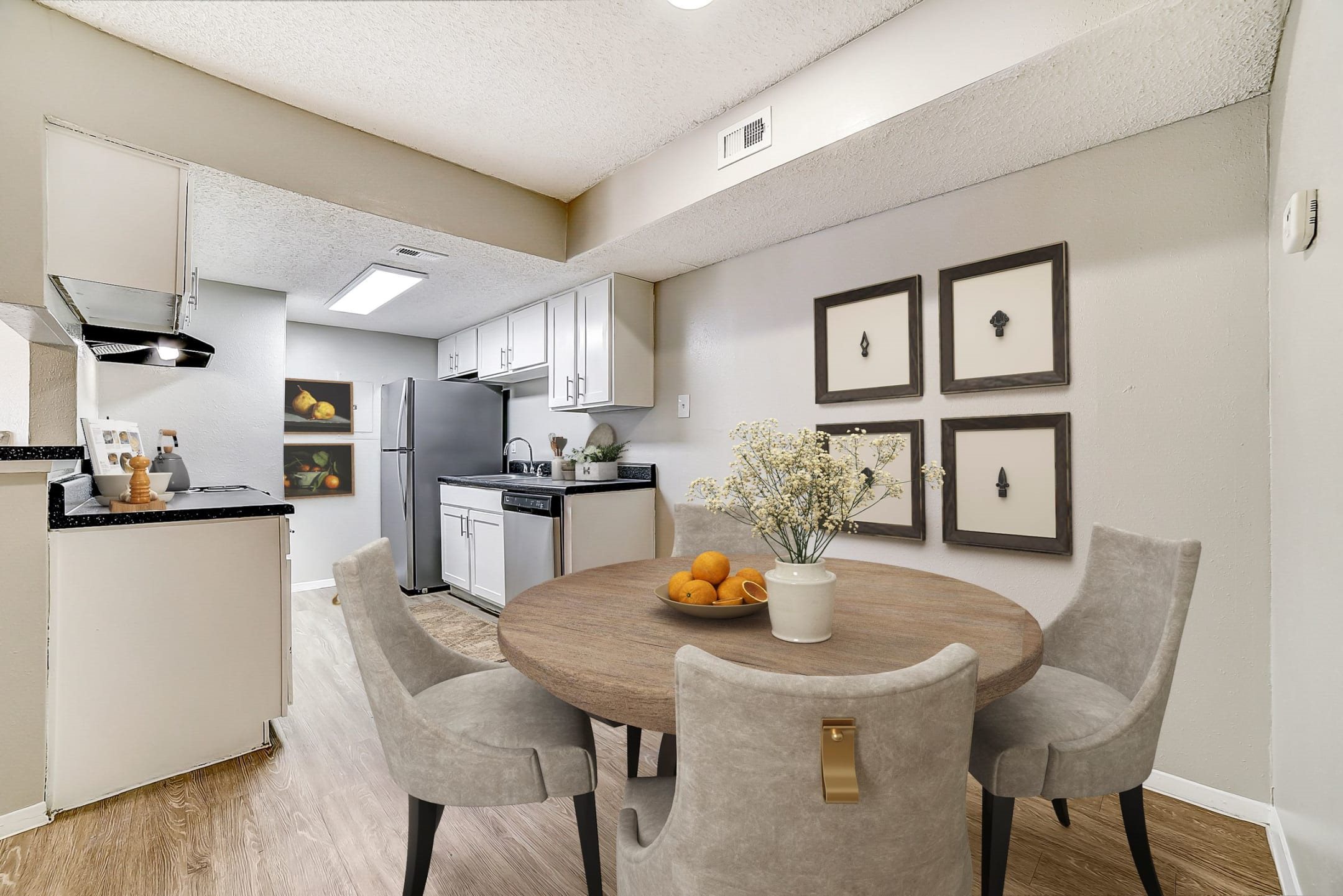 Dining room with round table and gallery wall at Peaks at Universal City Apartments, Universal City, 78148