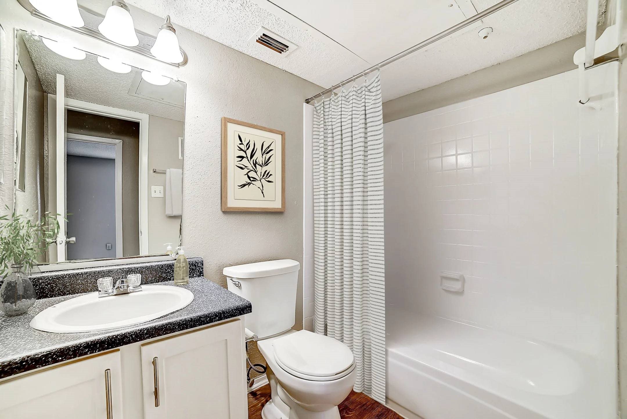 Bathroom with granite vanity and shower tub combo at Peaks at Universal City Apartments, Universal City, 78148