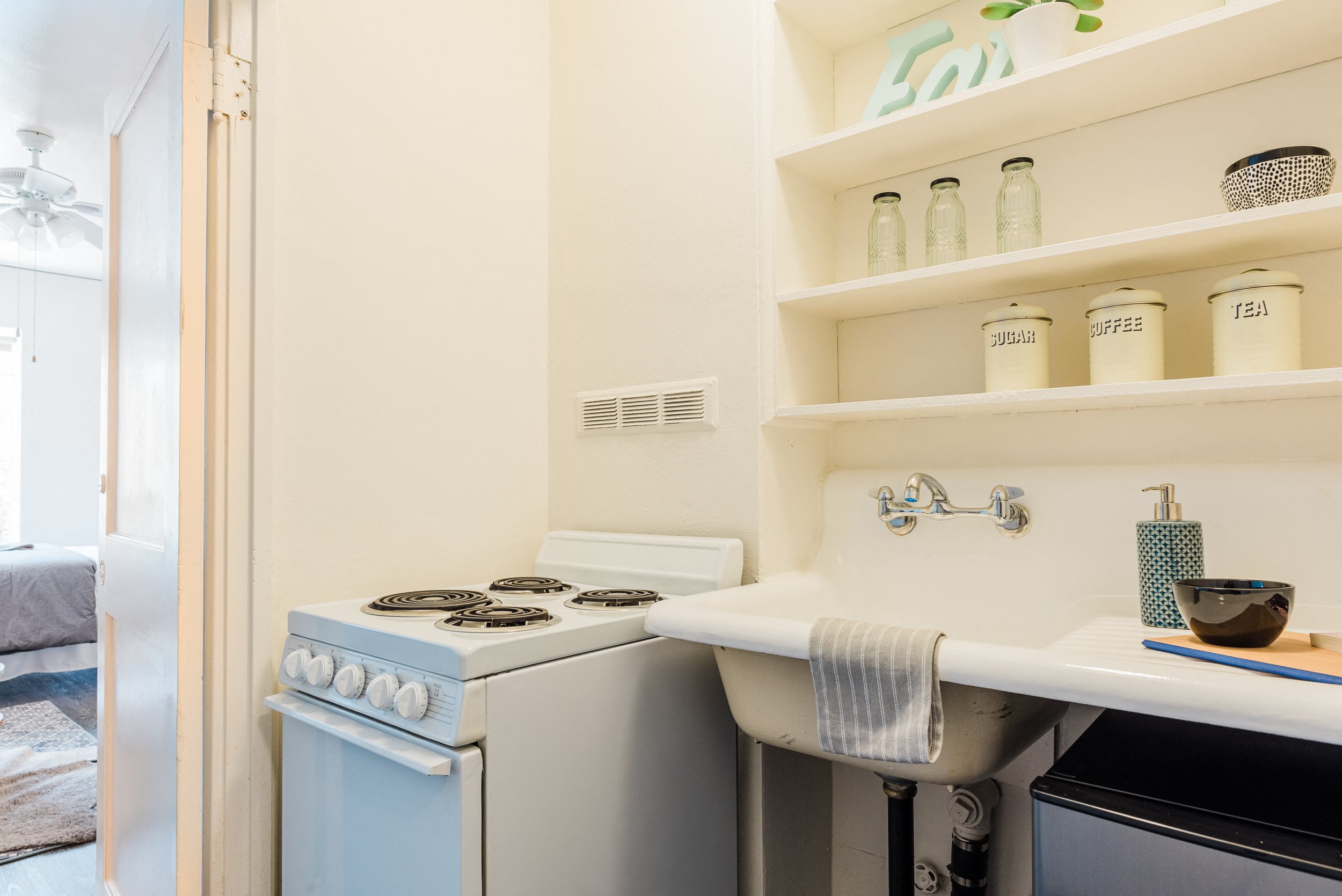 sample studio apartment full-size stove/oven in efficient kitchen