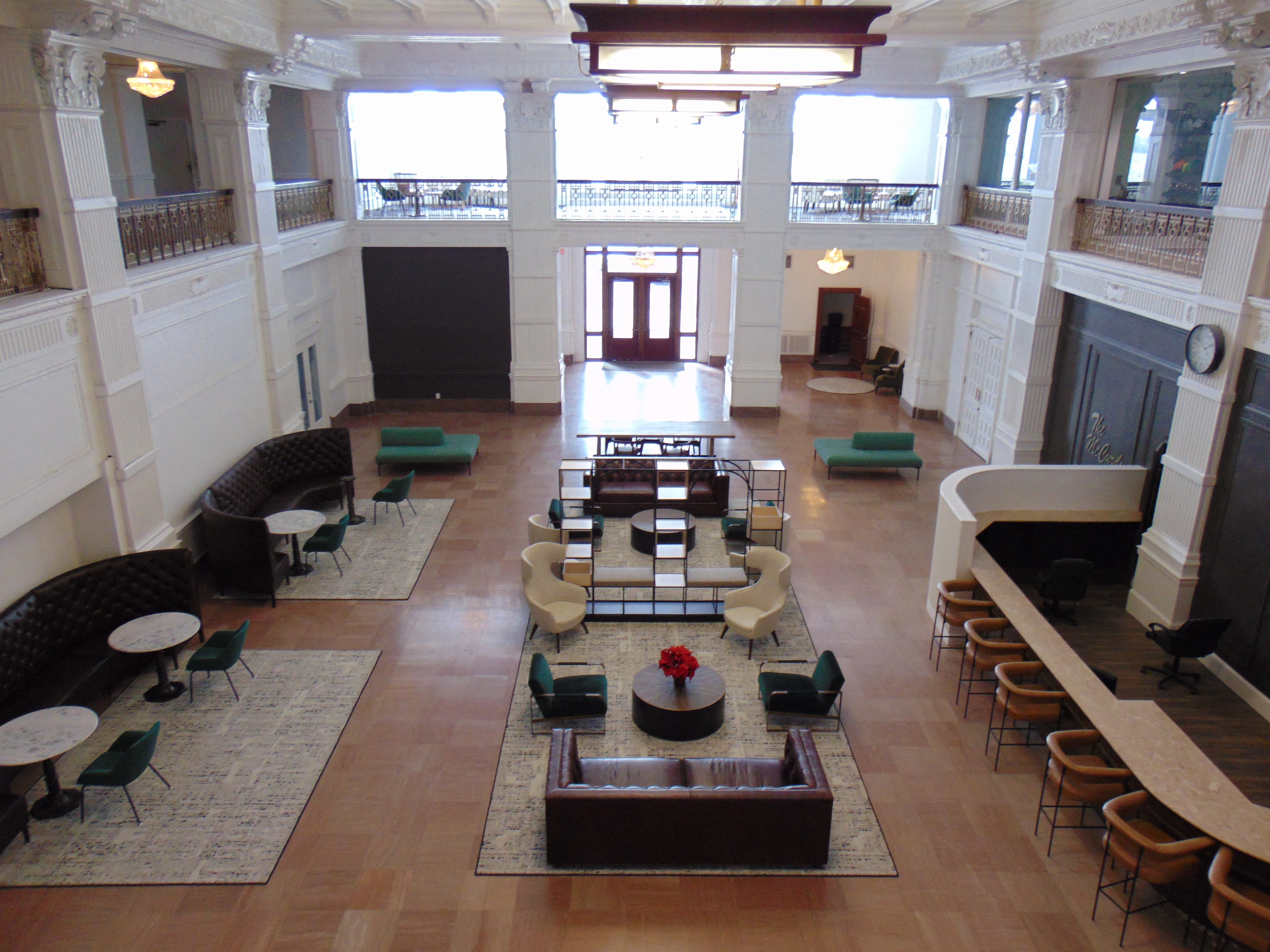 A large room with a fireplace and a long table with chairs on either side.