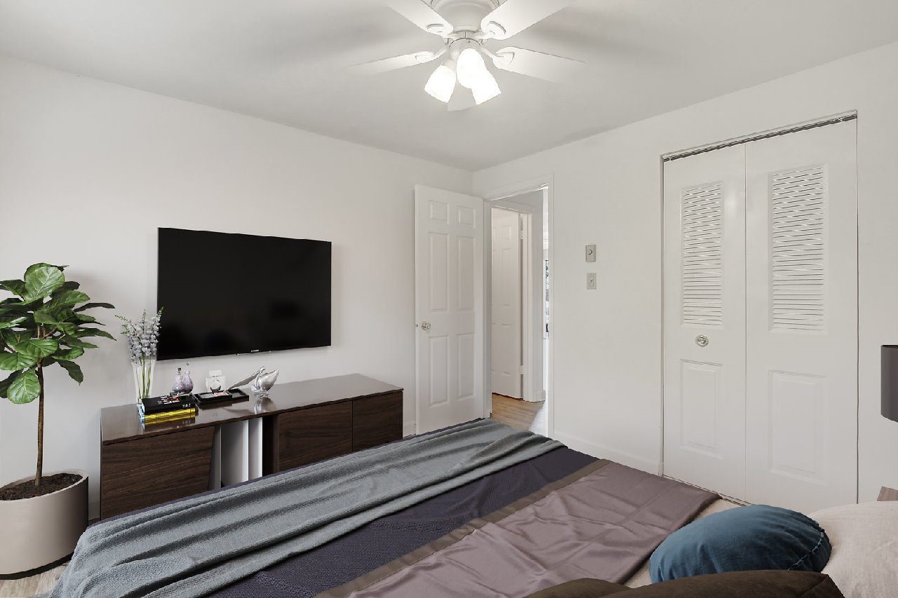A living room with a grey couch