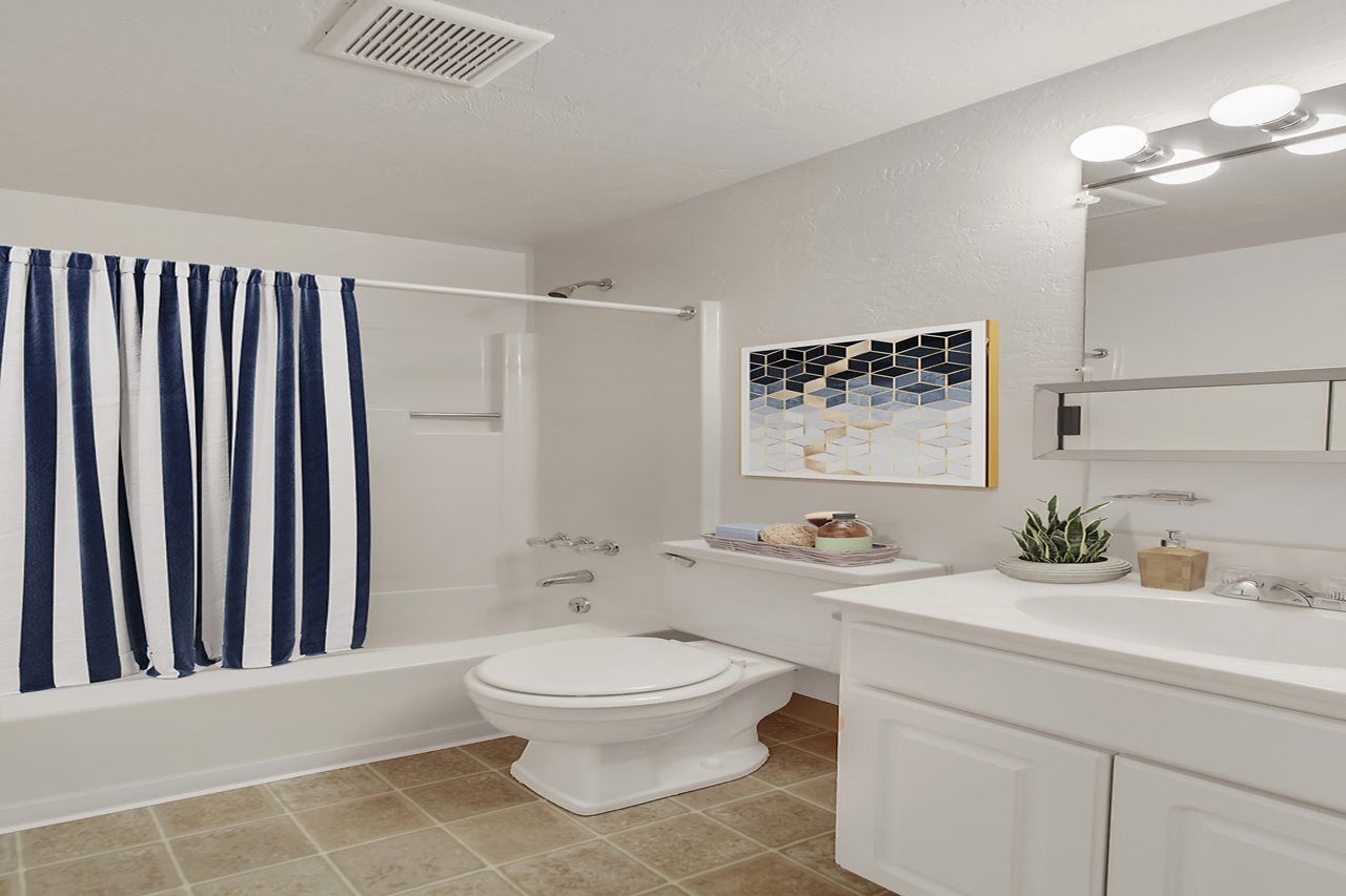 A living room with a white couch and a coffee table in front of it.