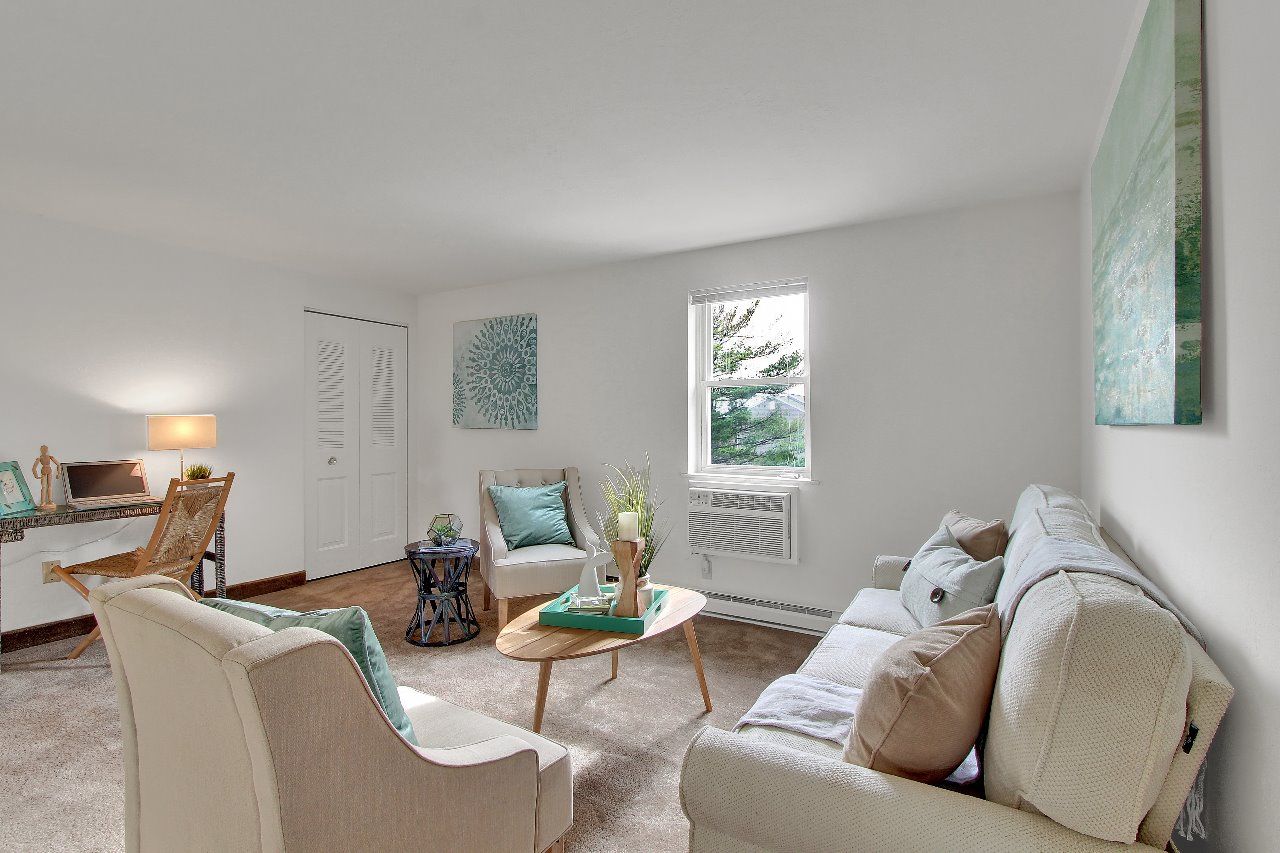 A living room with a fireplace and a painting on the wall.