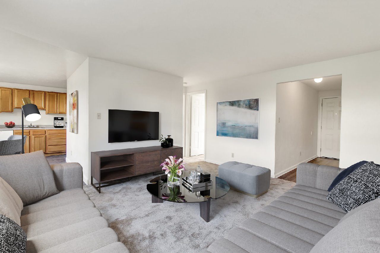 A living room with a grey couch and a coffee table.