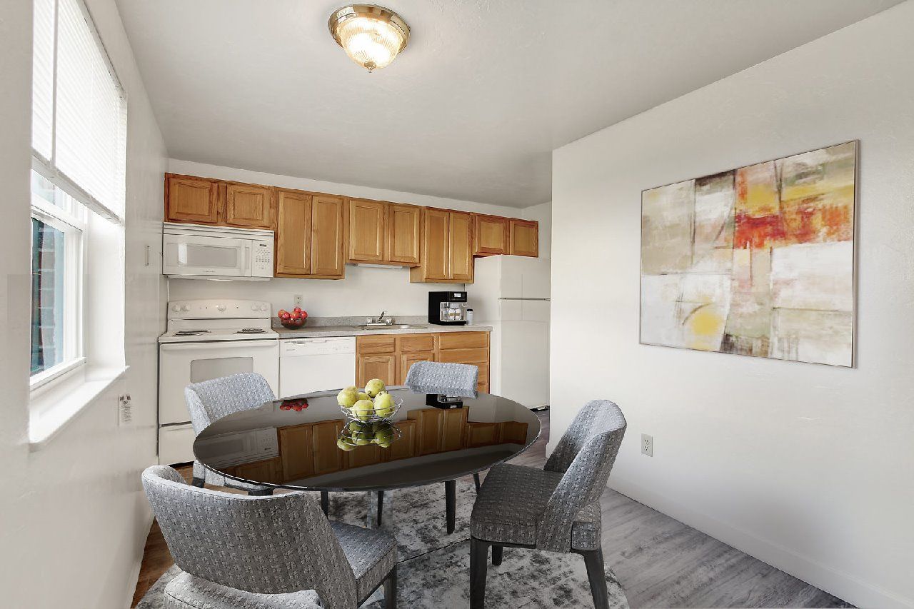 A dining room with a table set for two.