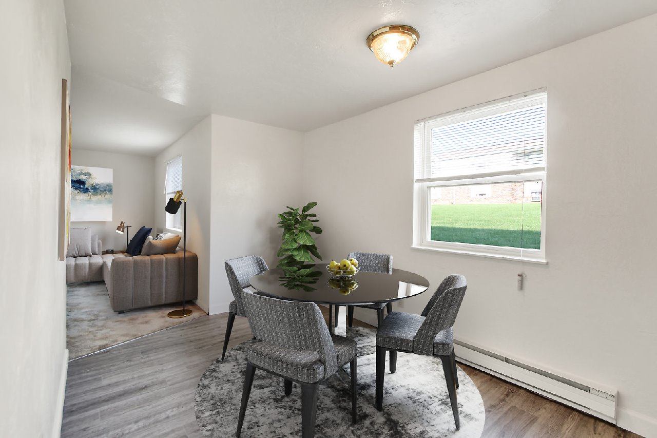 A dining room with a table and chairs.