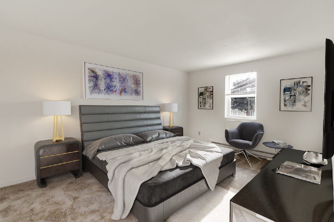 A bedroom with a large bed and a chair.