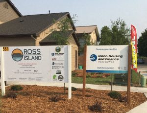 a couple of signs in front of a house