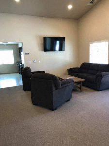 a living room filled with furniture and a flat screen tv