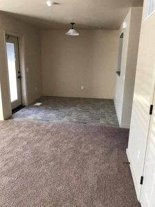 an empty room with a light hanging from the ceiling