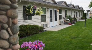 a house with a lawn and flowers in front of it