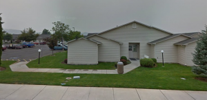 a white house with a yard in front of it