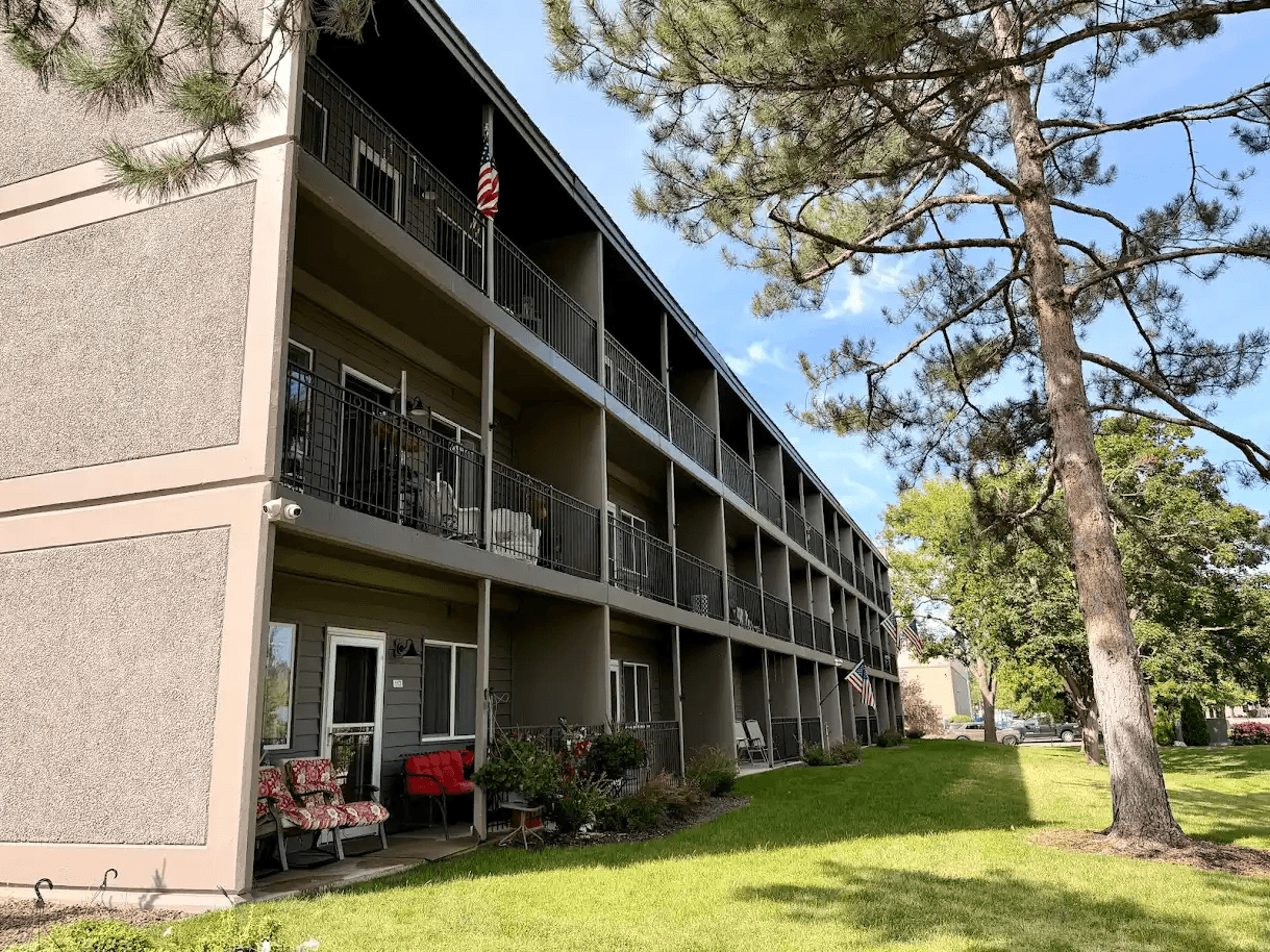 A building with a balcony and an American flag on it.