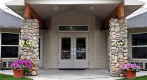 a building with a white door and two stone pillars