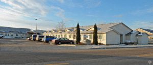a row of houses with cars parked in front of them
