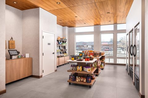A grocery store interior with a wooden ceiling and shelves stocked with products.