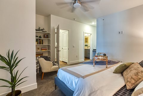 a bedroom with a bed and a ceiling fan
