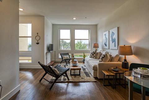 a living room with a couch chairs and a coffee table