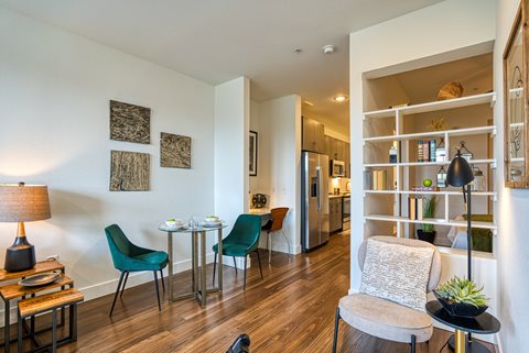 a living room with white walls and hardwood floors