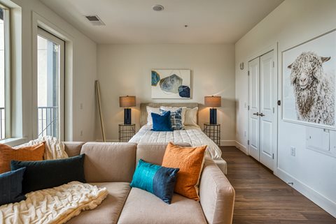 a bedroom with a bed and a couch in a 555 waverly unit