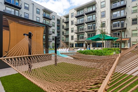 a hammock in front of an apartment building