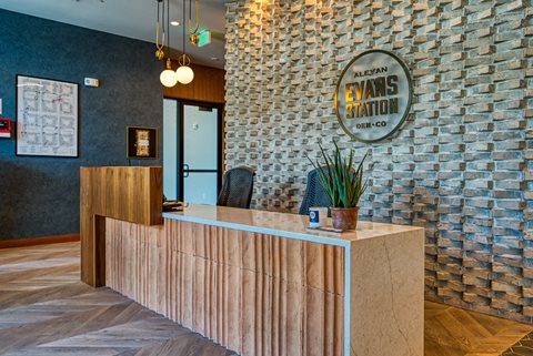 a reception desk with a brick wall behind it