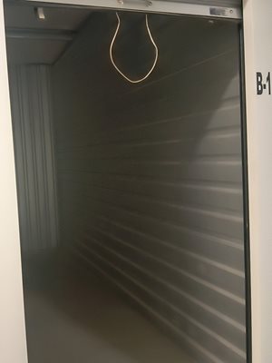A metal shelving unit with a wire hanging from the top.