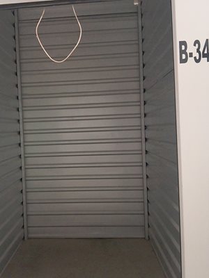 A white door with a number B-34 on the wall.