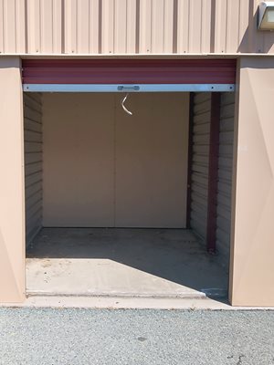 A white door is open to a garage.