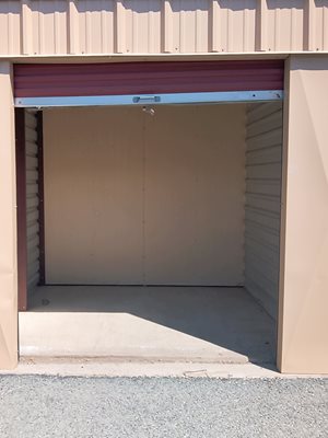 A closed garage door with a red roller.