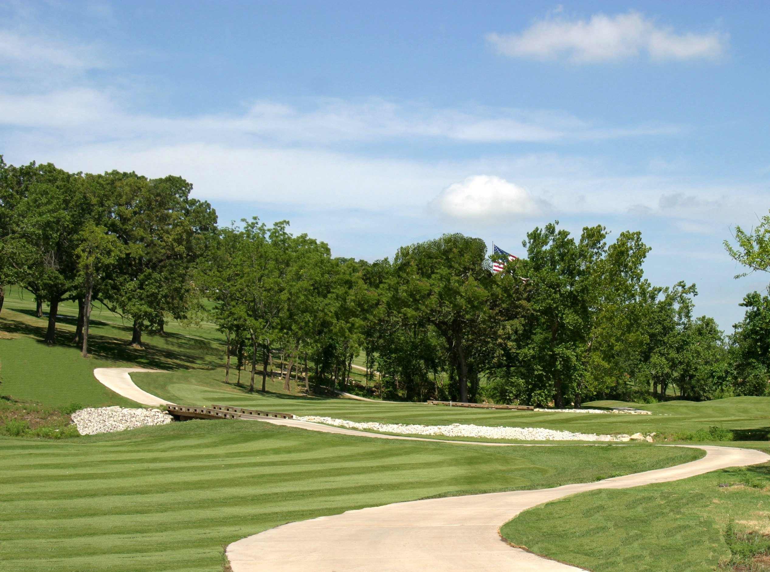 A golf course with a flag on the green.