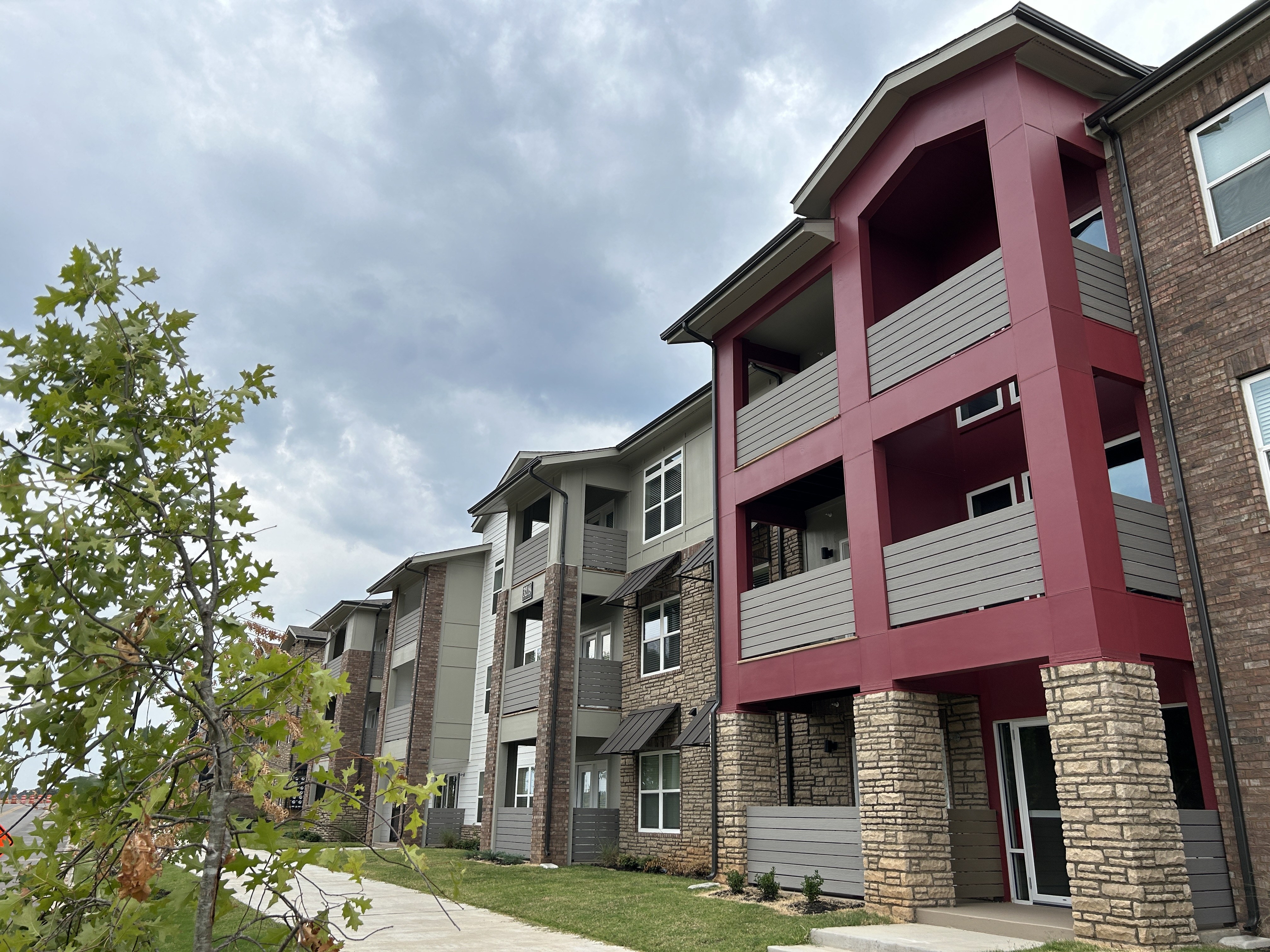 Apartment building with a red and grey facade.