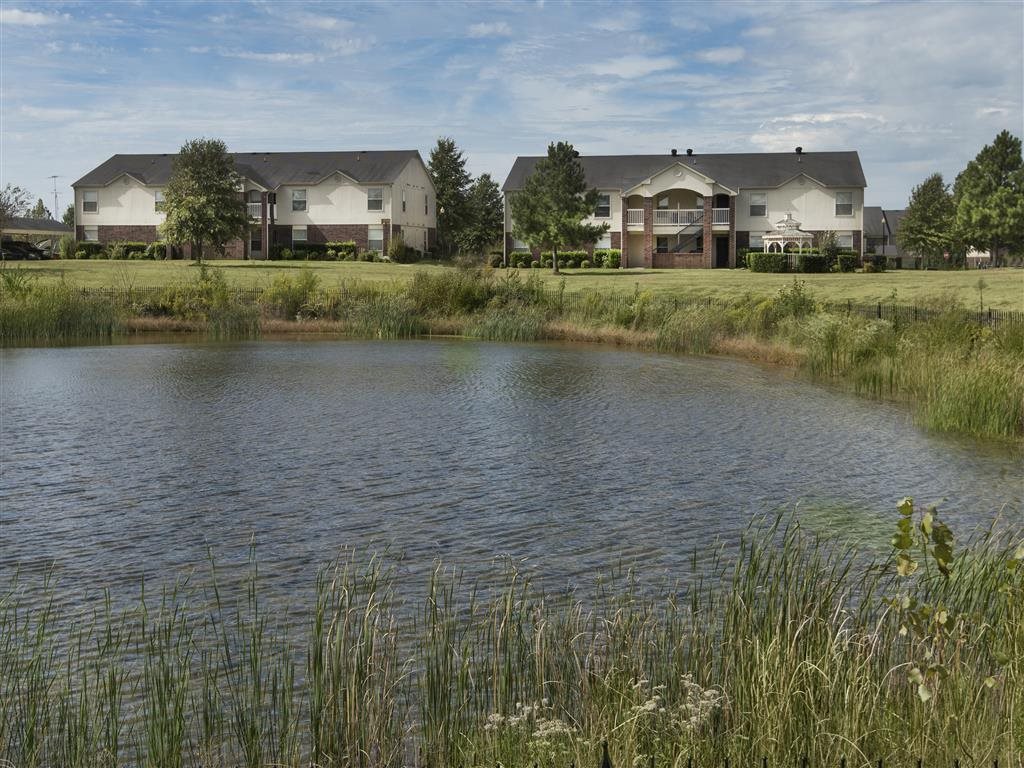 A pond in front of a row of houses.