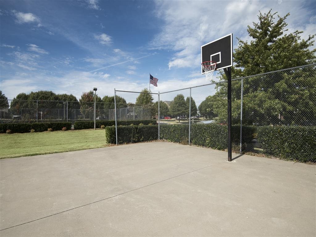 A basketball court with a hoop and an American flag.