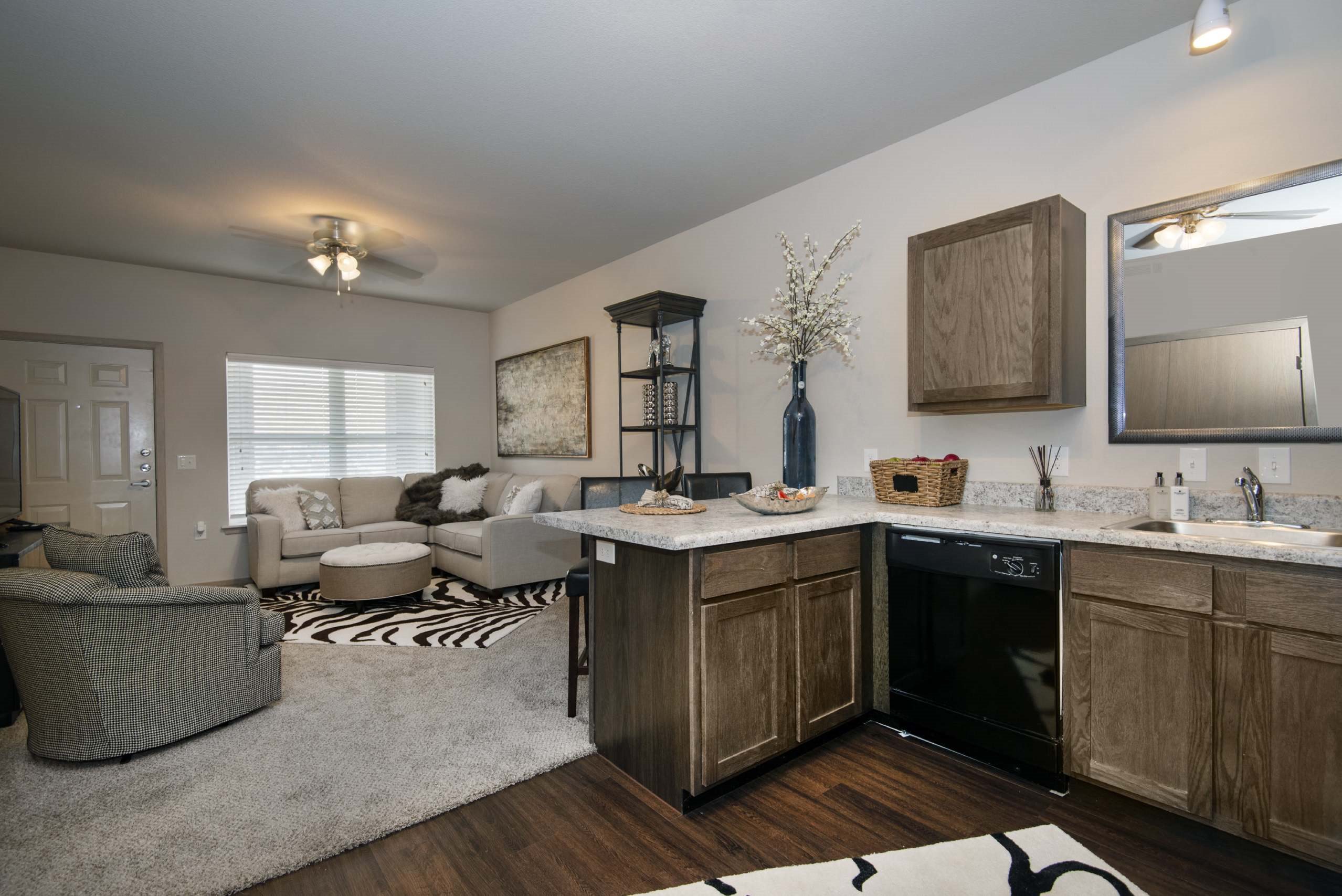 A modern kitchen with wooden cabinets and a black oven.
