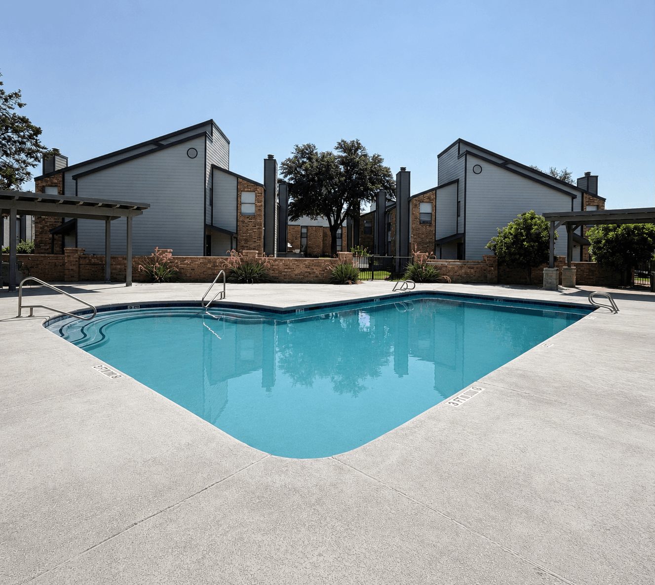 A swimming pool in front of a house.