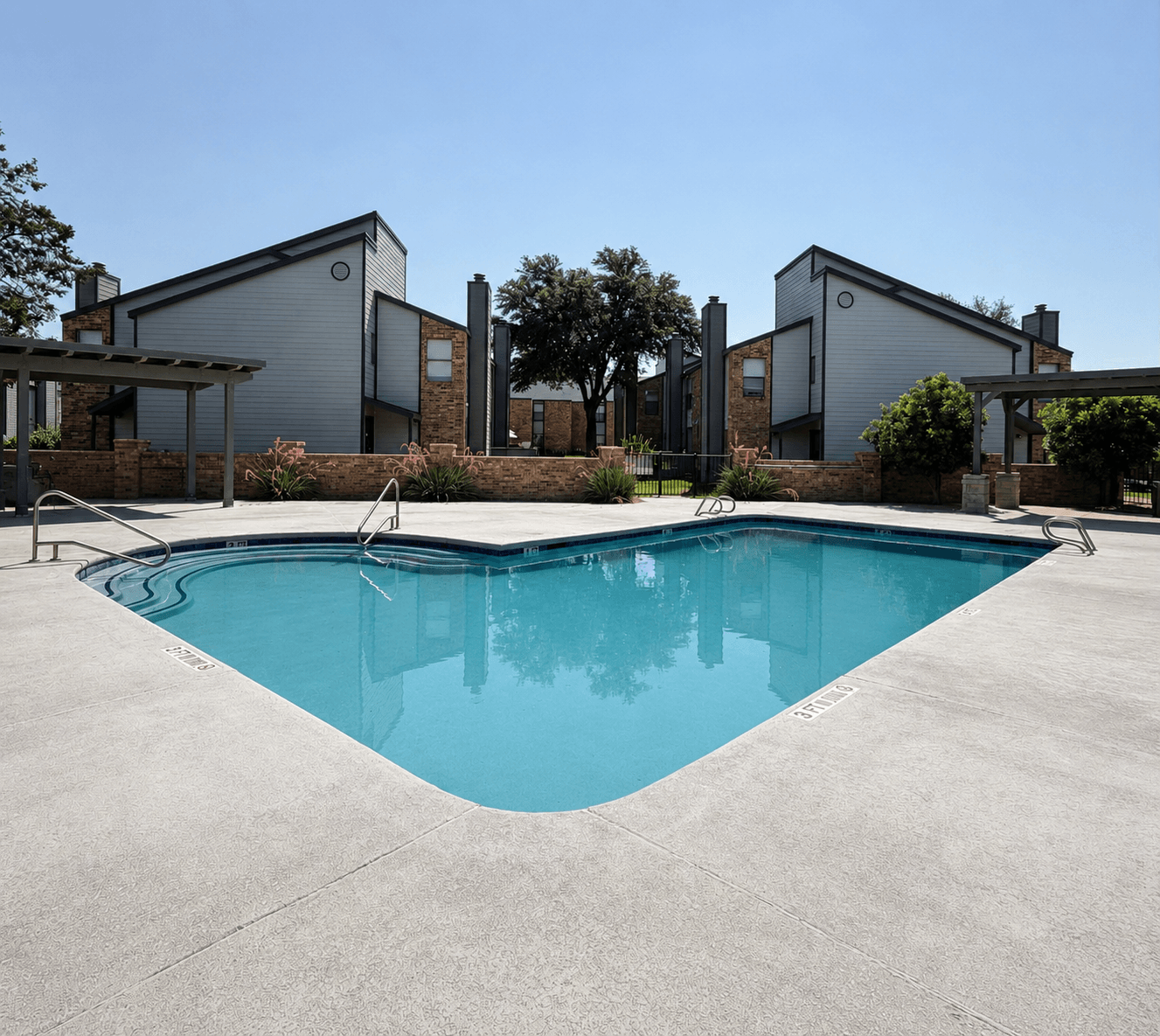 A swimming pool in front of a house.