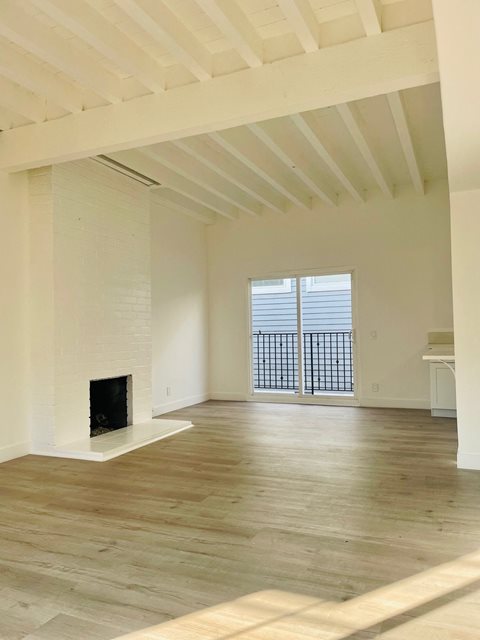 Living Room with High Ceilings and Hard Floors