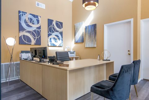 Leasing office with a wooden desk and black chairs at Stone Canyon apartments in Shreveport, LA.